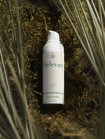 Delevan hydrating serum bottle on a natural background with plants