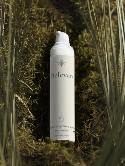 Delevan face lotion bottle on a natural background with plants